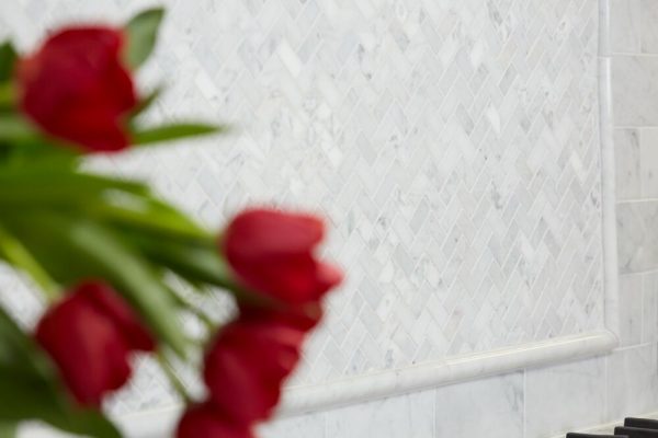 Carrara White Herringbone Pattern with Pencil Rail and Subway tile found at French Creek Designs in Casper, WY