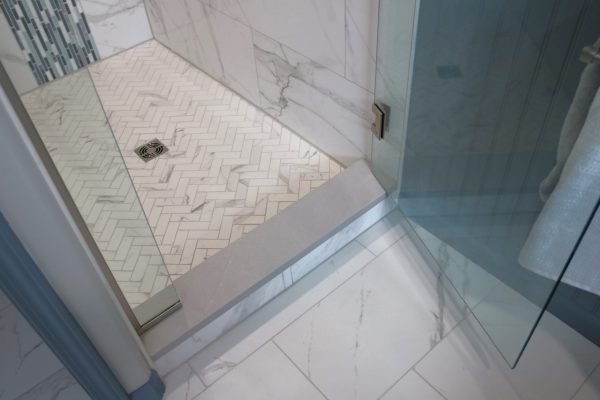 Client Bathroom Remodel 125, master bath shower design herringbone tile floor, quartz bench and threshhold