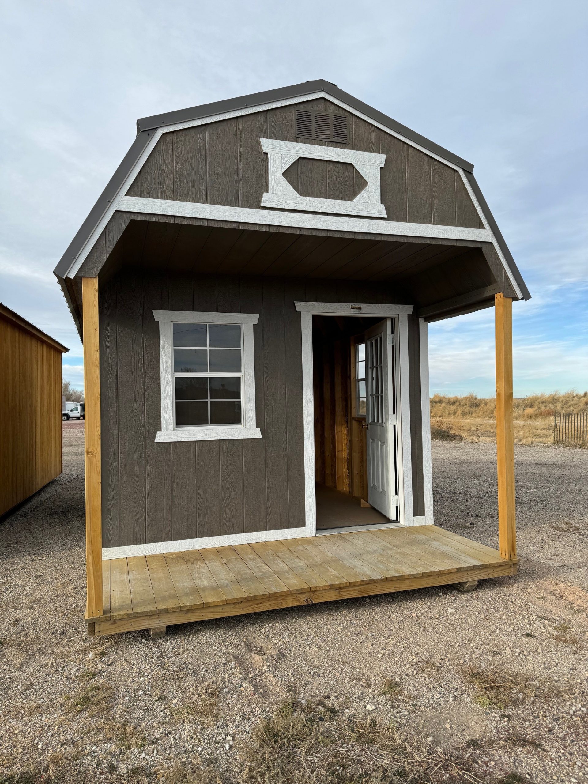 For Sale 10×20 Front Porch Shed For Sale Dark Ebony Urethane Paint Barn White Trim For Sale at French Creek Designs Shed Sales, Casper, Wyoming